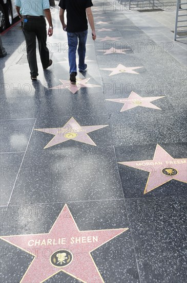 USA, California, Los Angeles, "Hollywood Walk of Fame along Hollywood Boulevard showing stars of Charlie Sheen, Morgan Freeman & Ricardo Montalban."