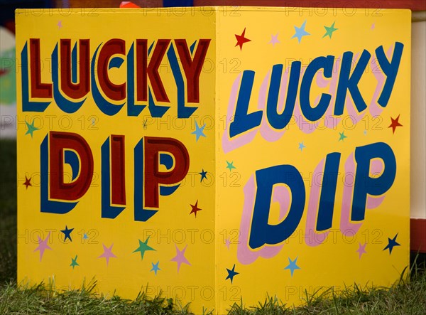 ENGLAND, West Sussex, Findon, Findon village Sheep Fair Colourful yellow sign for a Lucky Dip fairground stall.