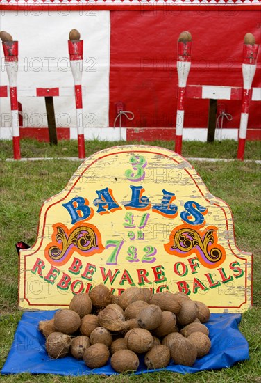 ENGLAND, West Sussex, Findon, Findon village Sheep Fair Coconut shy with sign reading Beware of Rebounding Balls.