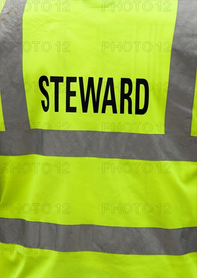 ENGLAND, West Sussex, Findon, Findon village Sheep Fair The reflective jacket of a Steward.