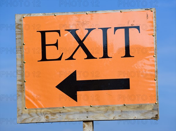 ENGLAND, West Sussex, West Dene, An orange sign with black writing that reads Exit and has an arrow pointing the way out.