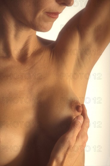 PEOPLE, Women, Health, Cropped shot of woman self examining her breast tissue.