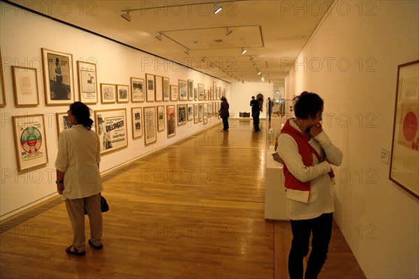 ENGLAND, East Sussex, Bexhill on Sea, De La Warr pavilion. Art Deco style building housing art gallery and theatre. People in gallery looking at exhibition of posters by Joseph Beuys.