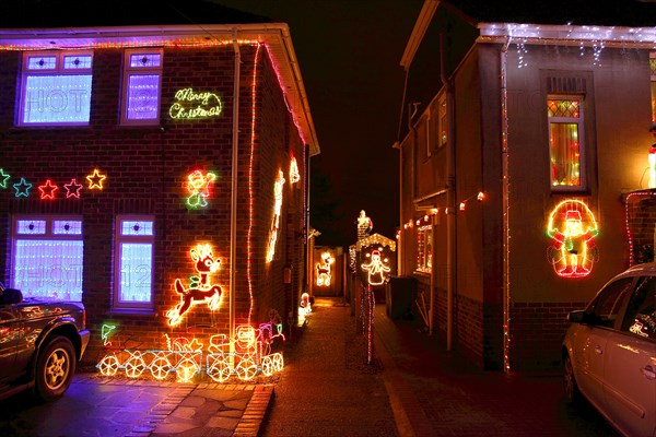 ENGLAND, West Sussex, Southwick, Cul de Sac of houses decorated with fairy lights for Christmas.