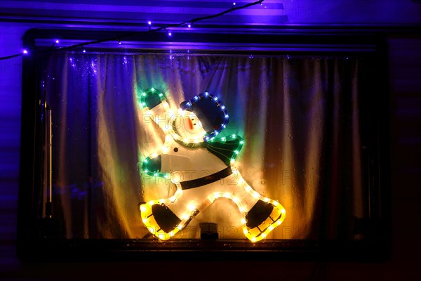 ENGLAND, West Sussex, Southwick, Caravan decorated with fairy lights for Christmas.