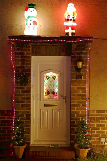 ENGLAND, West Sussex, Southwick, Cul de Sac of houses decorated with fairy lights for Christmas.