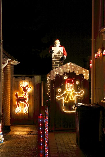 ENGLAND, West Sussex, Southwick, Cul de Sac of houses decorated with fairy lights for Christmas.