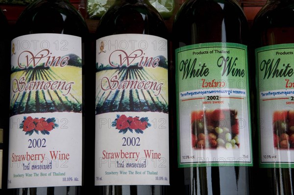THAILAND, North, Chiang Mai, Samoeng. Close up of locally produced strawberry wine bottle labels.