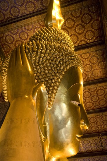 THAILAND, Central, Bangkok, Wat Pho also known as Wat Phra Chetuphon. Close up of the face of the large reclining buddha statue.