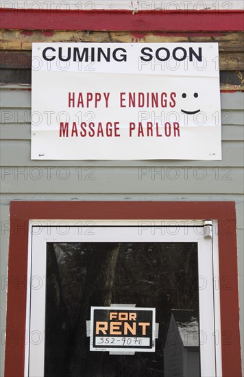 USA, New Hampshire, Keene, "Sign on building, cuming soon, Happy Endings Massage Parlor."