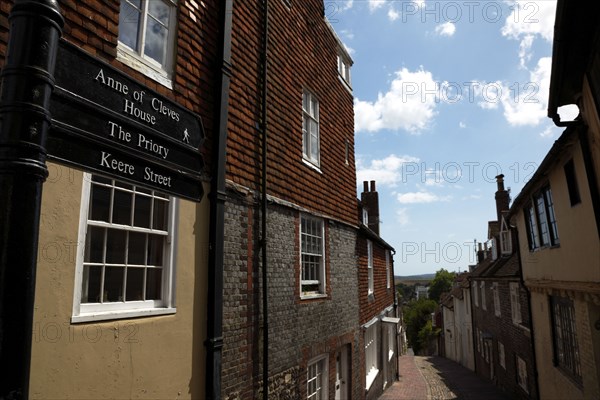 ENGLAND, East Sussex, Lewes, "High Street, Keere Street cobbled pathway with traditional buildings."