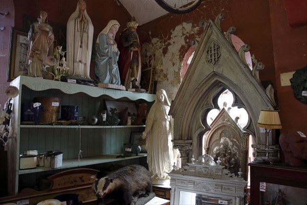 ENGLAND, East Sussex, Lewes, "North Street, Flea Market antigues and second hand goods shop. Christian statues of Mary on sale."