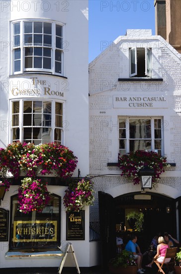 ENGLAND, East Sussex, Brighton, The Lanes People at tables outside The Cricketers one of the oldest pubs in the city dating from 1547 which featured in Graham Greenes Brighton Rock has an upstairs bar called the Greene Room full of Graham Greene memorabilia.