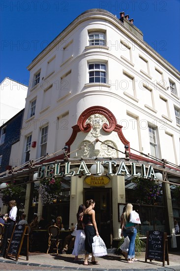 ENGLAND, East Sussex, Brighton, The Lanes Bella Italia Italian restaurant with diners at tables on the pavement sidewalk and shoppers walking past.