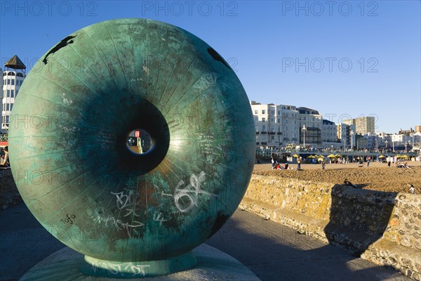 ENGLAND, East Sussex, Brighton, The green bronze Doughnut sculpture on one of the groynes on the seafront.