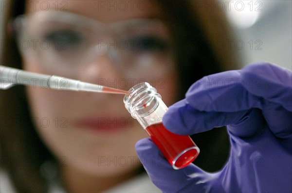 SCIENCE, Biology, Technician, Worker wearing protective glasses and gloves filling pipette with liquid from bottle. Scottish Life Science Awards 2009.