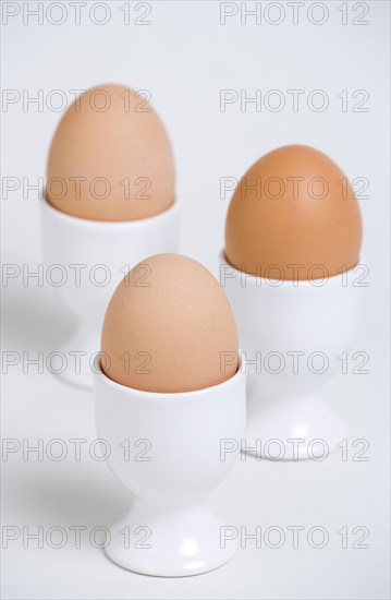FOOD, Uncooked, Eggs, Three boiled free range eggs in egg cups.