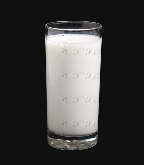 DRINK, Milk, Glass, Tumbler glass of dairy milk on a black background.