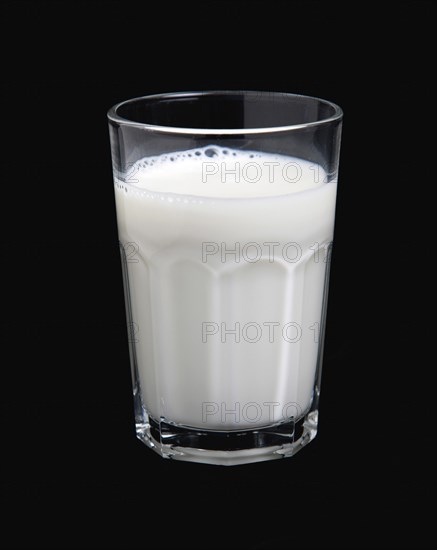 DRINK, Milk, Glass, Tumbler glass of dairy milk on a black background.