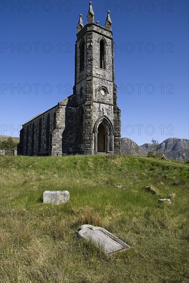 IRELAND, County Doneghal, Poisoned Glen, Ruined Church of Ireland building with gravestone in foreground.