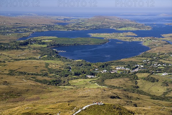 IRELAND, County Galway, Connemara, Diamond Hill, Ballynakill Harbour as seen from the slopes of the hill  Hikers at viewpoint.
