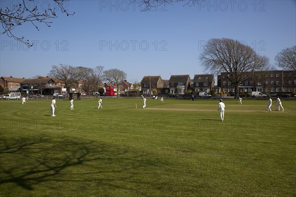 England, West Sussex, Southwick, Local Cricket team playing on village green.