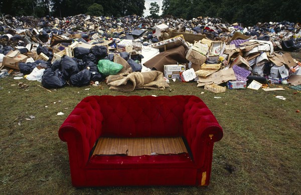 Environment, Litter, Red sofa surrounded by a mountain of other rubbish dumped in a public park during a council workers strike in Liverpool.