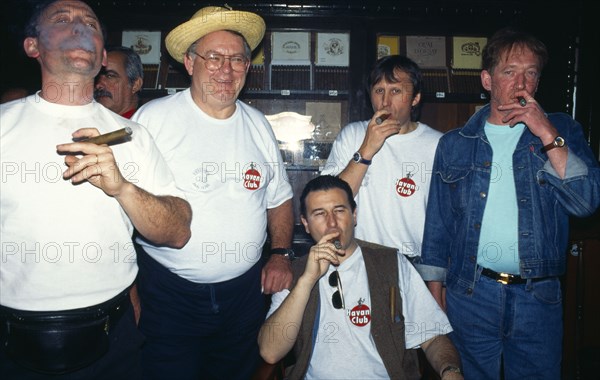 CUBA, Havana, Partagas cigar factory shop interior with visiting group smoking cigars.