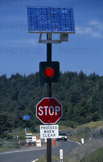 Environment, Solar Power, USA, California.  Solar powered red warning light on traffic light next to road side.