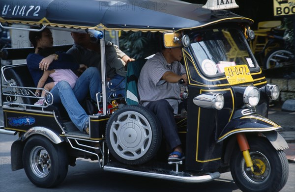 Thailand, North, Chiang Mai, Local family with young child as passengers in a Tuk Tuk three wheeled motorbike taxi.