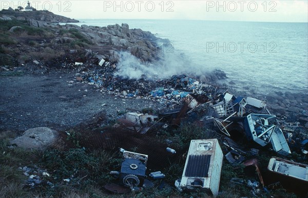 Pollution, Environment, Dumped fridges at watersedge releasing CFC gases into the atmosphere, along with household rubbish burning.