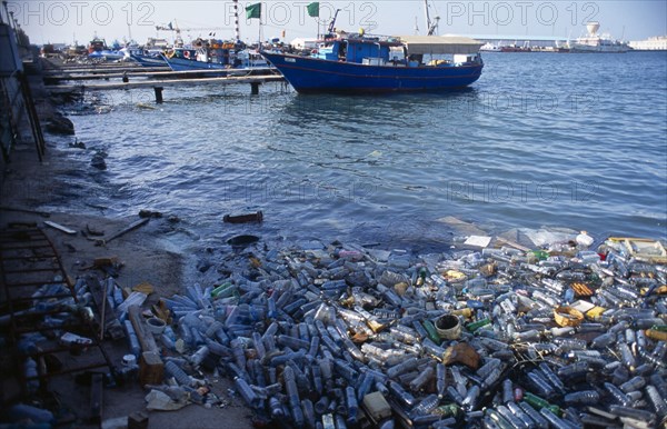 Libya, Tripolitania, Tripoli, Plastic water bottles and other rubbish polluting harbour.