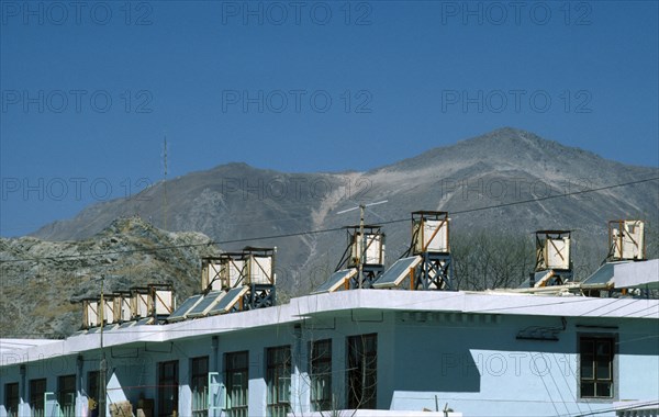 Tibet, Lhasa, Solar panels on roof of building.