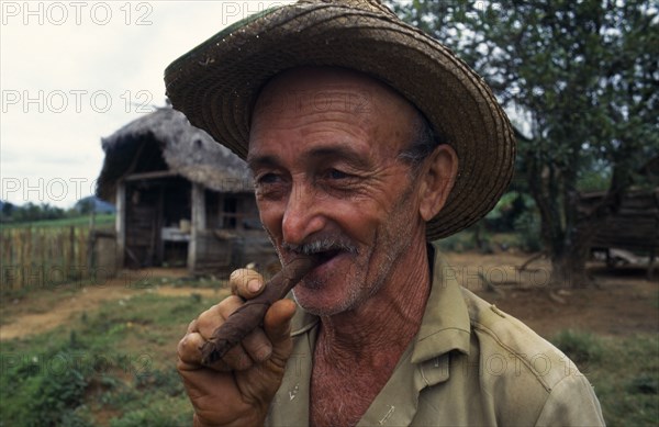 CUBA, Vinales, Portrait of tobacco planter smoking cigar.