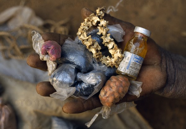 Burkina Faso, Bisaland, Sigue Voisin Village, Cropped view of man holding handful of homemade medicine using traditional recipes in village near Garango.