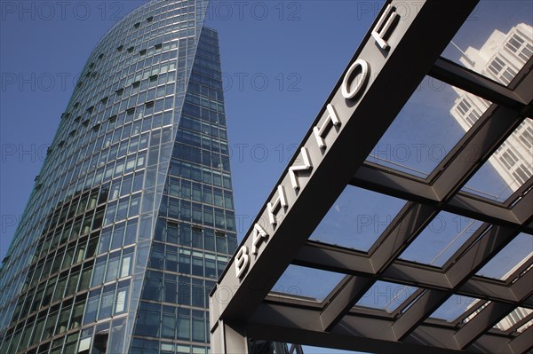 Germany, Berlin, Bahnhof station sign & office building at Potsdamer Platz.