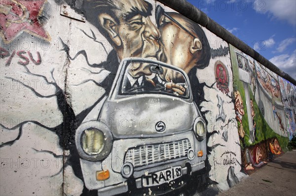 Germany, Berlin, Mural of Erich Honecker & Leonid Brezhnev kissing in a car, East Side Gallery, Berlin Wall.