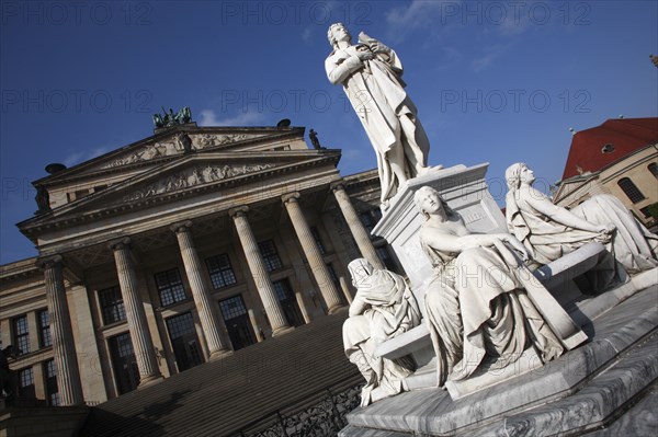 Germany, Berlin, Gendermenmarkt, Schiller Monument with the concert hall in the background to the left.