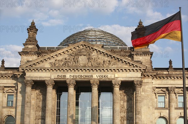 Germany, Berlin, Reichstag with the national flag to the right.