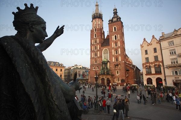 Poland, Krakow, Detail of female figure on monument to the polish romantic poet Adam Mickiewicz by Teodor Rygier in 1898 in the Rynek Glowny market square with Mariacki Basilica or Church of St Mary in the background.