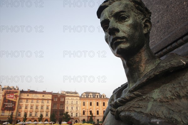 Poland, Krakow, Detail of female figure on monument to the polish romantic poet Adam Mickiewicz by Teodor Rygier in 1898 in the Rynek Glowny market square with Mariacki Basilica or Church of St Mary in the background.