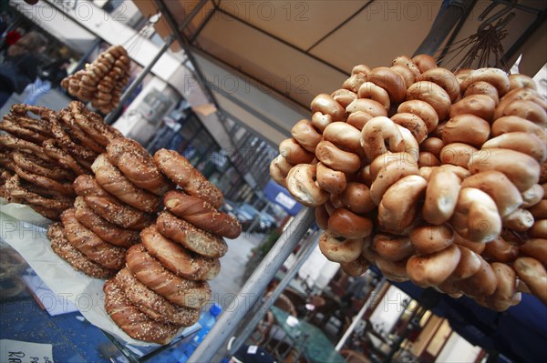 Poland, Krakow, Obwarzaneck, street vendors stall selling twisted rings of bread strewn with poppy seeds.