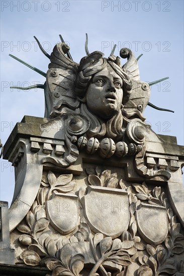 Poland, Krakow, Head of Apollo on top of the entrance to the Palace of Arts built in 1901 for the Society of Fine Arts Friends.