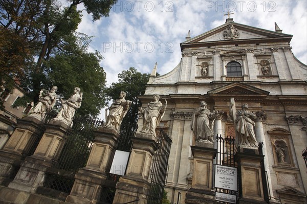 Poland, Krakow, Church of St Peter & St Paul with statues of the apostles in the foreground.