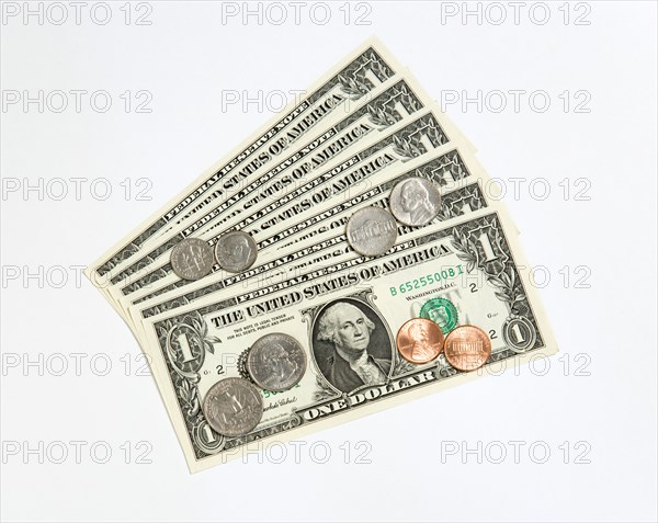 Business, Finance, Money, US Currency Paper one dollar banknote and coins of one cent penny five cent nickel ten cent dime and twenty five cent quarter.