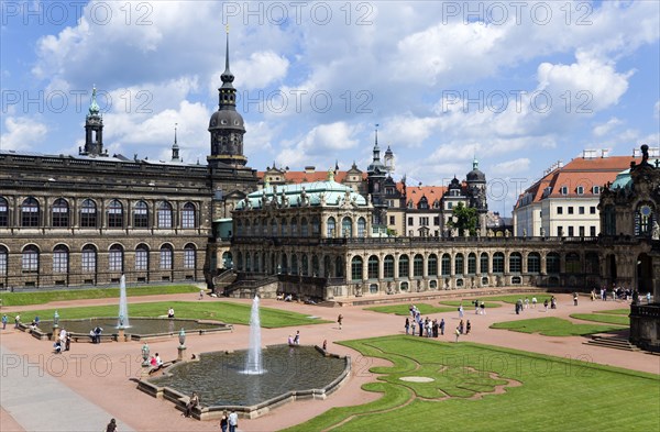 GERMANY, Saxony, Dresden, The central Courtyard of the restored Baroque Zwinger Palace gardens busy with tourists originally built between 1710 and 1732 after a design by Matthäus Daniel Pöppelmann in collaboration with sculptor Balthasar Permoser.