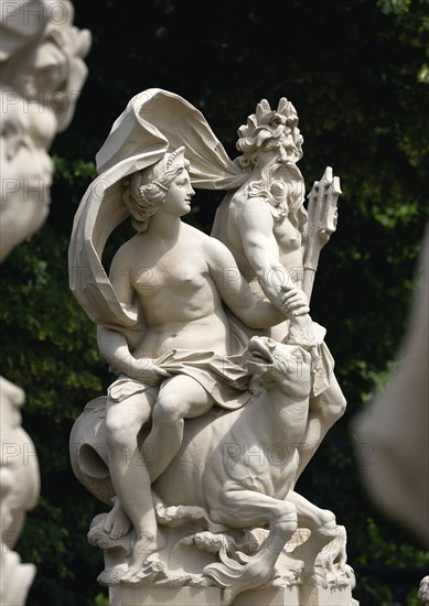 GERMANY, Saxony, Dresden, Statue of a naked women seated on a seahorse beside a bearded man possibly the sea god Neptune holding a trident in the restored Baroque Zwinger Palace Gardens.