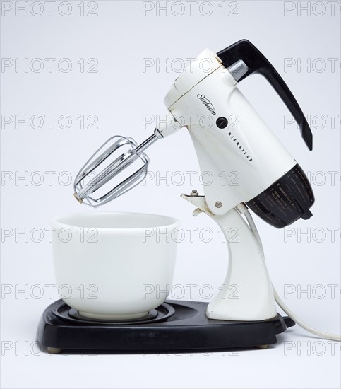 Food Preparation, Cooking, Kitchen Equipment, Sunbeam Mixmaster electric food blender or mixer circa 1953 on a white background.