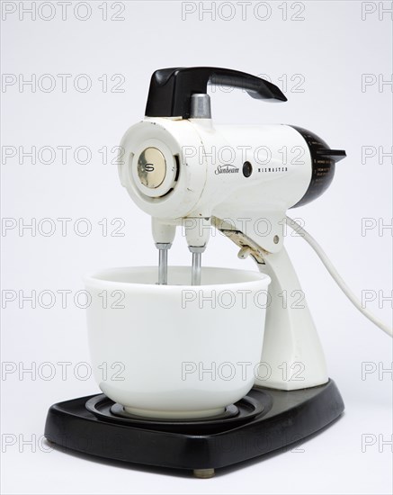 Food Preparation, Cooking, Kitchen Equipment, Sunbeam Mixmaster electric food blender or mixer circa 1953 on a white background.