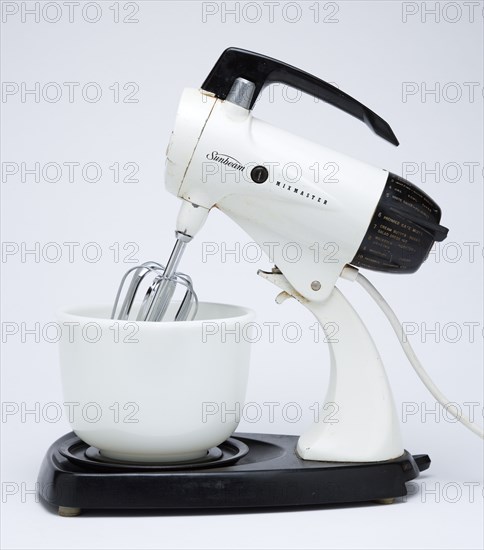 Food Preparation, Cooking, Kitchen Equipment, Sunbeam Mixmaster electric food blender or mixer circa 1953 on a white background.